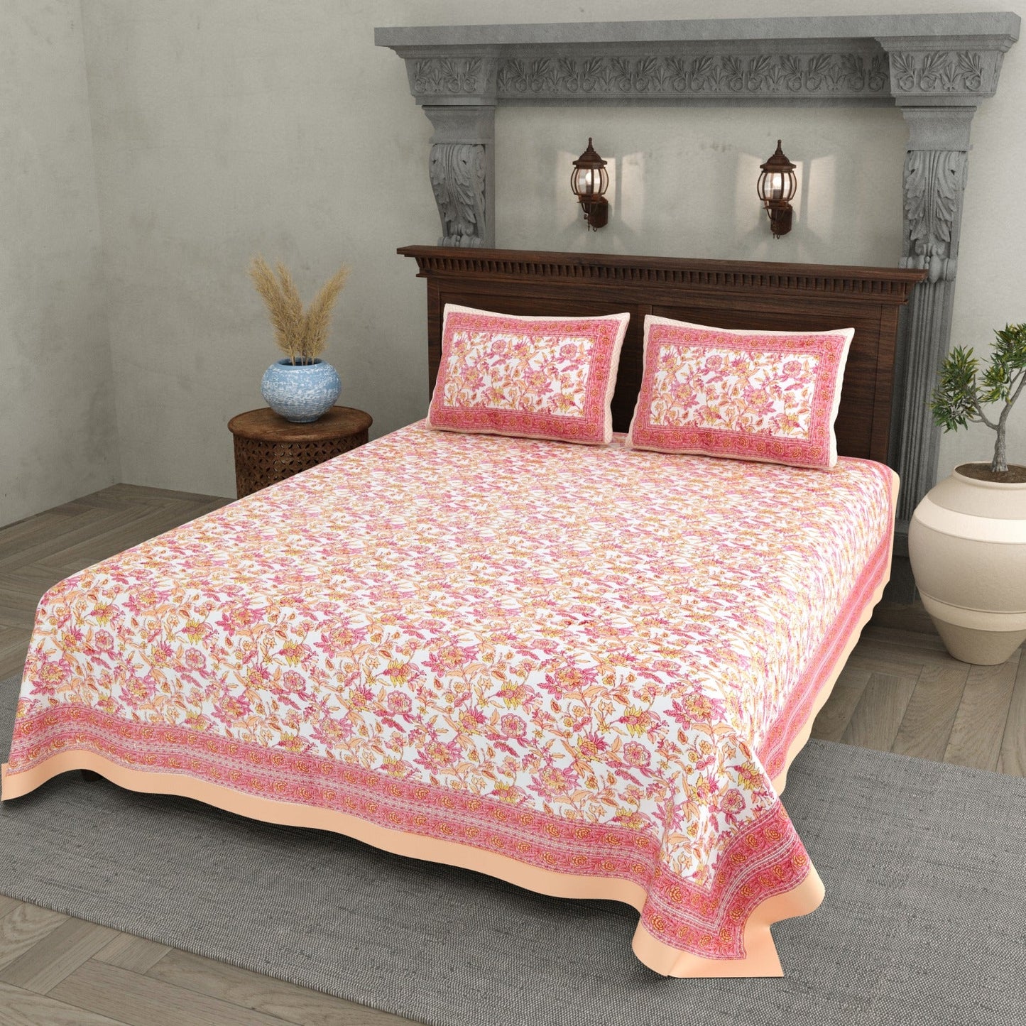 Double bed peach cotton bedsheet with two pillow covers on a bed