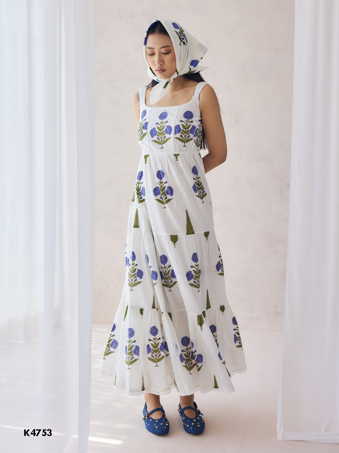 White one piece dress with blue floral embroidery on cotton fabric