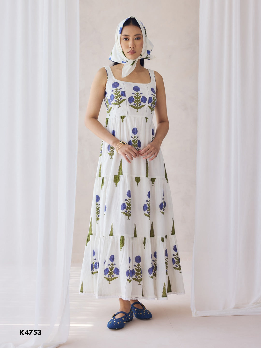 White one piece dress with blue floral embroidery on cotton fabric