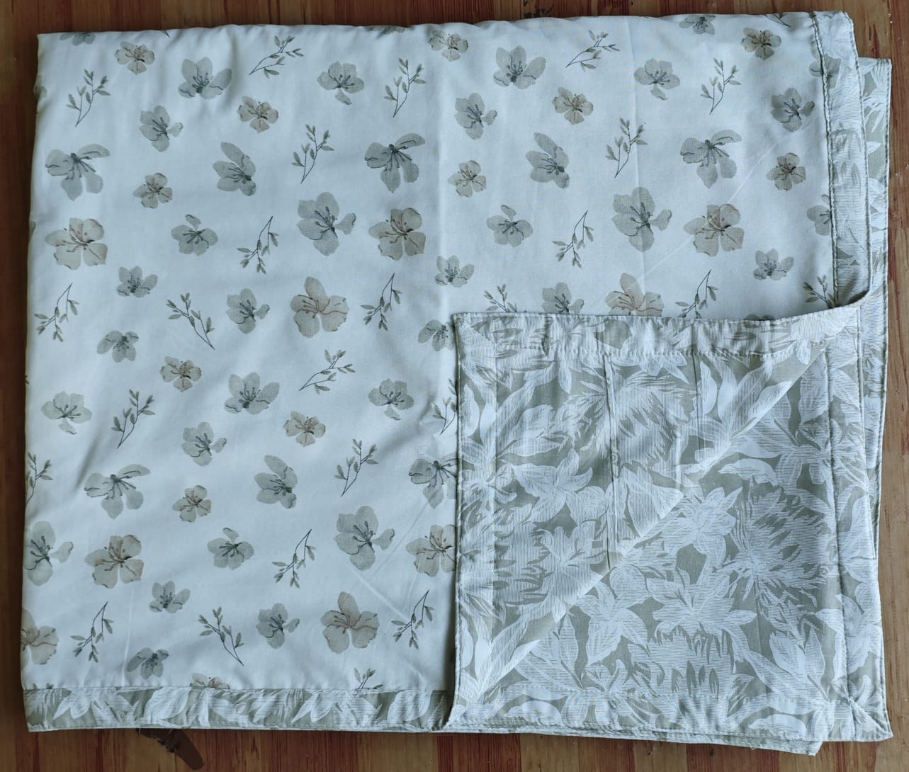 Reversible cotton double bed dohar in dull cotton fabric displayed on bed