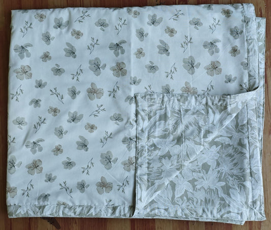 Reversible cotton double bed dohar in dull cotton fabric displayed on bed