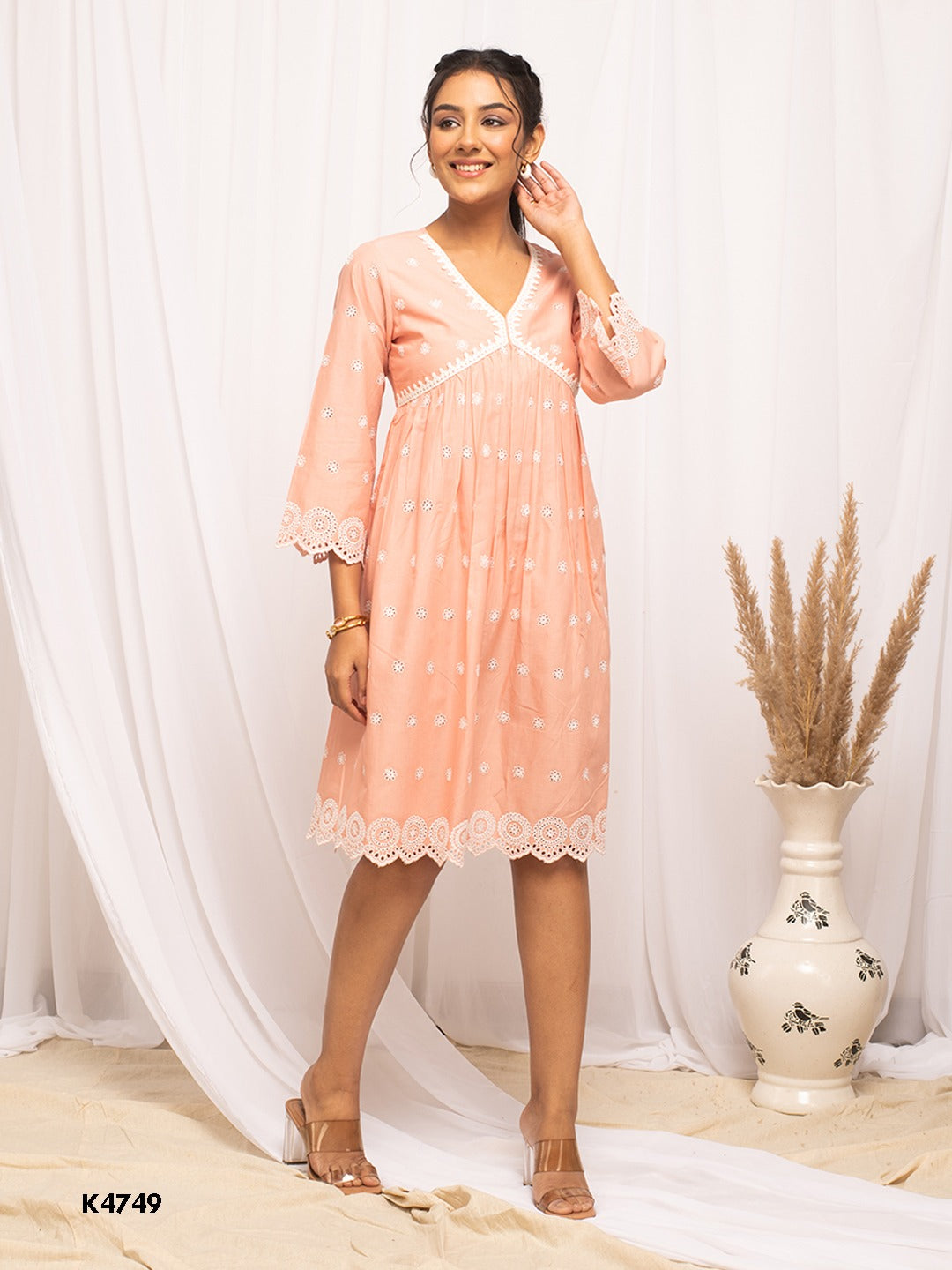 Woman wearing peach cotton embroidered one-piece dress beach wear